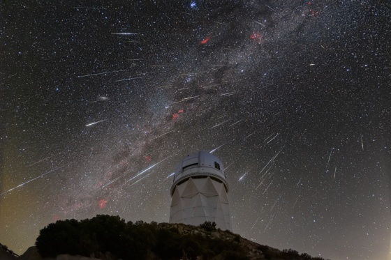 Meteors from the Geminid meteor shower streak across the sky