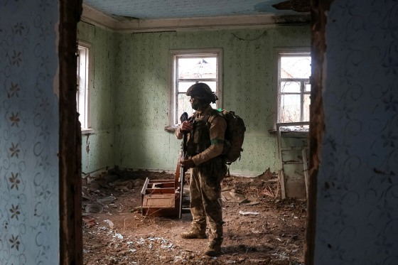 Ukrainian serviceman hides from a Russian combat drone in a building damaged by Russian military strike in the frontline town of Kostiantynivka