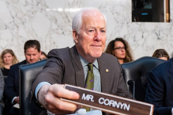 Image: Sen. John Cornyn, places his nameplate down as he arrives for the Senate Judiciary Committee hearing on "Protecting Our Children Online Against the Evolving Offender"