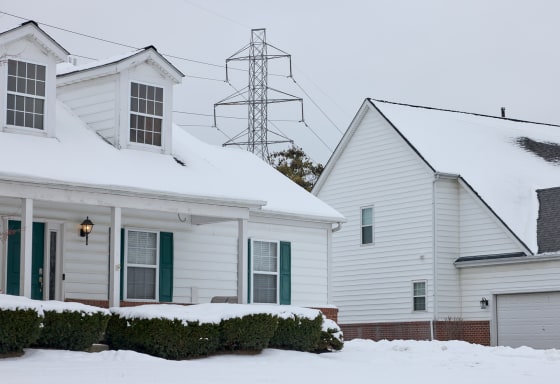A power transmission line behind homes in a residential neighborhood in Columbus, Ohio, on Tuesday. 