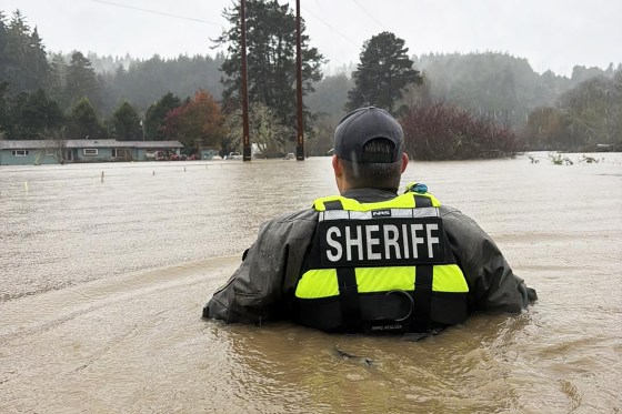 A Humboldt County sheriff's official in flooded waters in Freshwater, Calif., on Sunday.