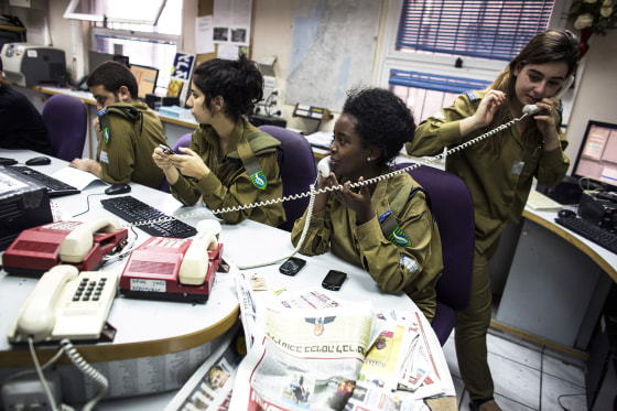 Israeli soldiers from Galei Tzahal, the Israeli army radio station, work in the newsroom at the station's studios in Jaffa