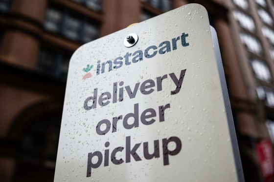 An Instacart sign speckled with raindrops outside
