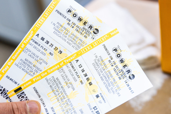 A clerk holds Powerball lottery tickets.