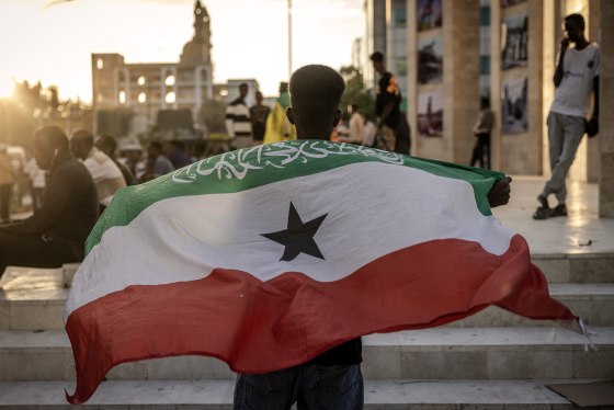 A man holds a flag of Somaliland in front of the Hargeisa War Memorial monument in Hargeisa on Nov. 7, 2024. 