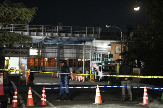 A police officer stands guard inside the cordon at the Yokohama Rubber Mishima Plant in Mishima, Shizuoka Prefecture on Dec. 26.