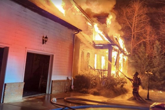 Firefighters battle a blaze at the home of Denny Hamlin’s father following a fatal house fire.