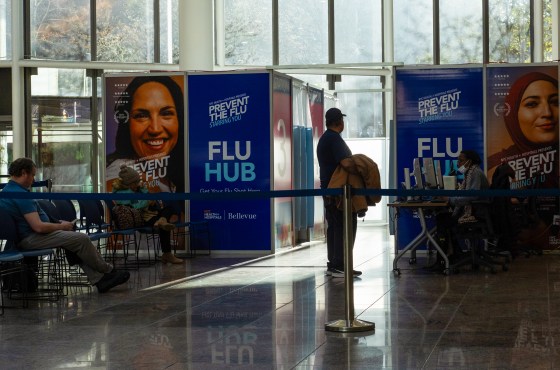 People seated in a cordoned off area of Bellevue Hospital called "Flu Hub"