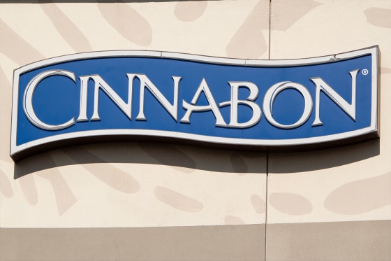 The Cinnabon corporate logo is displayed on a sign at their shop.