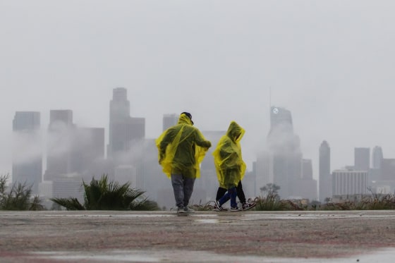 A family walks in the rain at Elysian Park on Dec. 24, 2025 in Los Angeles, California