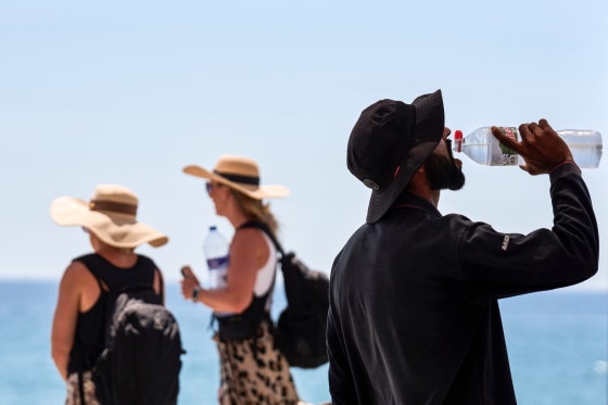 A tourist drinks water