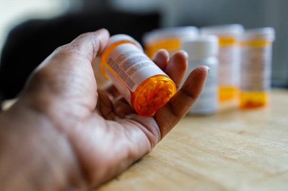 Woman Holds Bottle of Prescription Medication