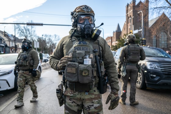 Federal law enforcement agents stand on the street outside