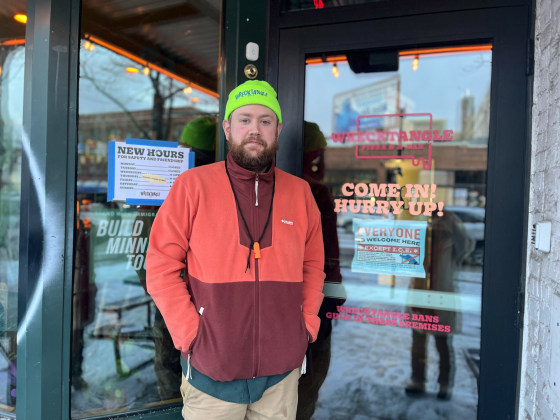 Jeff Rogers stands in front of the doorway to Wrecktangle Pizza