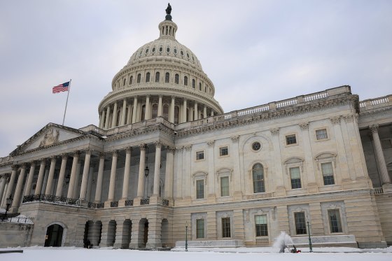 Workers clear snow outside the U.S. Capitol