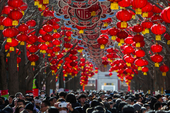 People gather at a holiday market in a park during Lunar New Year celebrations marking the Year of the Horse, in Beijing, China.