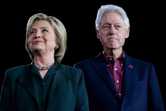 Hillary Clinton, left, and Bill Clinton stand next to each other