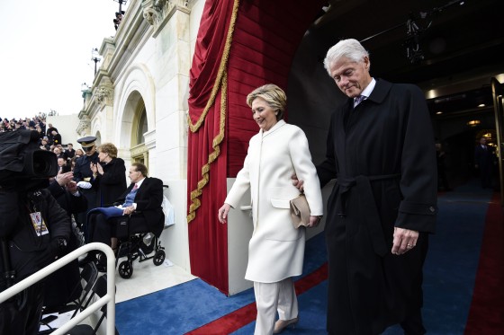 Hillary Clinton and Bill Clinton walk out of a building together