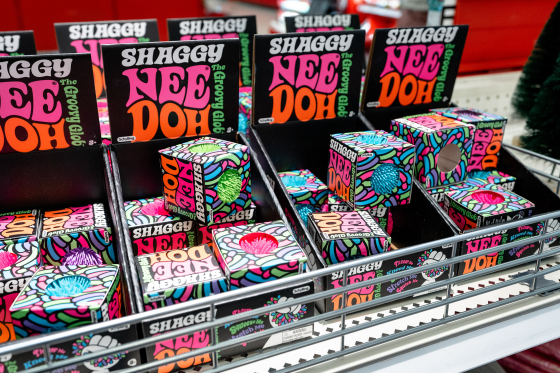 Neon lettering on several display boxes reads SHAGGY NEEDOH THE GROOVY GLOB.