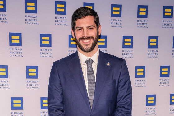 Alex Bores posing at the Human Rights Campaign for his portrait to be taken.