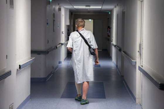 A patient walks down a corridor to get some exercise