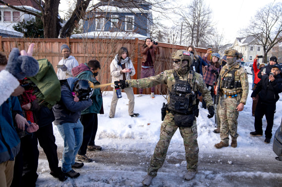 An agent sprays pepper spray at a protestor attempting to block an immigration officer vehicle in Minneapolis on Jan. 7. Funding for the Department of Homeland Security ended early Saturday, though Immigration and Customs Enforcement has other funds available.
