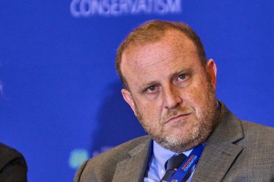 Jeremy Carl staring away while wearing a suit and a tie.