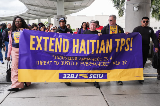 People march during a rally in support of the extension of Temporary Protected Status (TPS) for Haitian immigrants.
