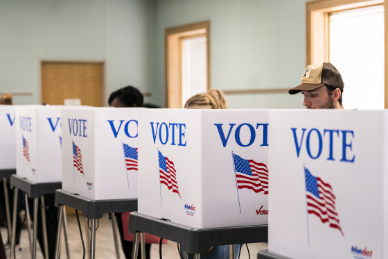 Voters cast ballots at a polling location.