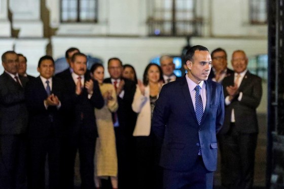 Peru's impeached interim President Jose Jeri walks out of the Government Palace as his cabinet applauds him
