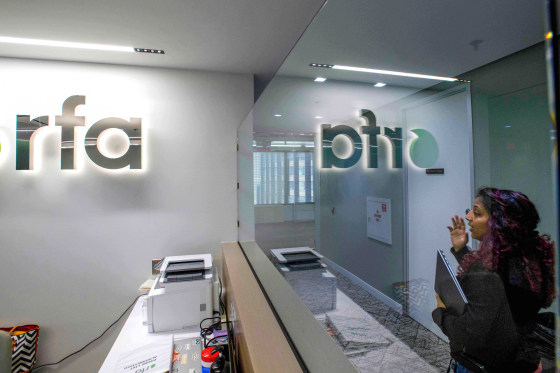 A woman walking past the empty receptionist desk at Radio Free Asia in Washington in April.