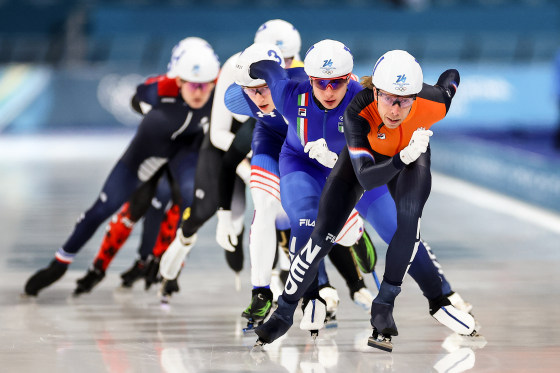 A group of speed skaters competing on the ice.