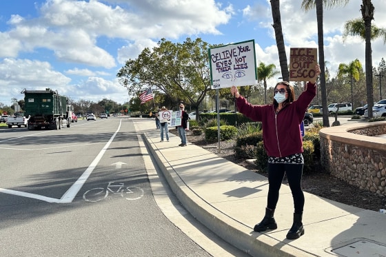 Demonstrators protest against ICE outside a police station in Escondido, Calif. 