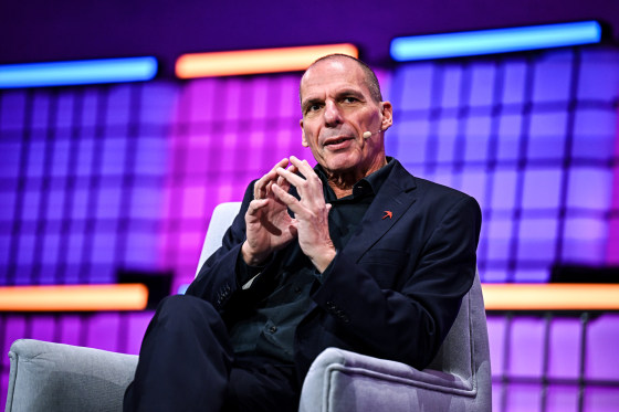 Yanis Varoufakis speaks while seated on stage