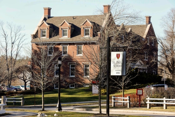 A large red brick four-story building with a sign reading St. Paul's School.