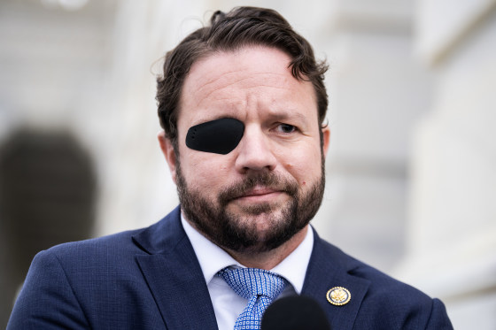 Dan Crenshaw appears outside the U.S. Capitol while wearing a black eyepatch on his right eye.