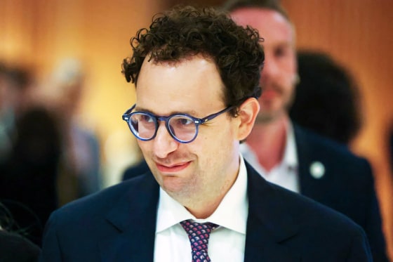 Anthropic CEO Dario Amodei looks smiles as he appears to be walking.