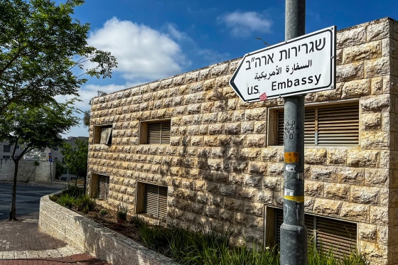 A road sign shows the way towards the U.S. Embassy
