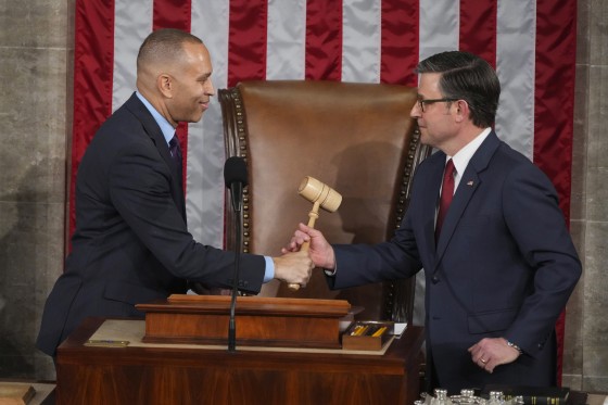 House Minority Leader Hakeem Jeffries, D-N.Y., left, hands the gavel to House Speaker Mike Johnson, R-La.