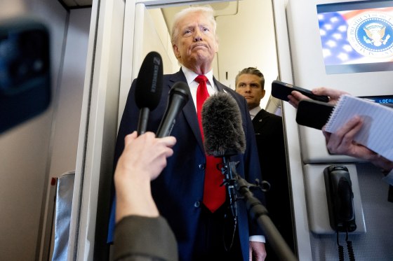 President Trump speaks to the media alongside Defense Secretary Pete Hegseth on Air Force One on March 7, 2026.