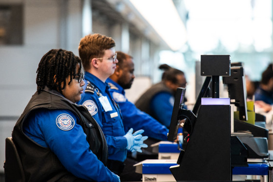 TSA agents seated at their stations