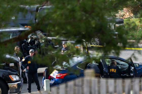 FBI officials examine a vehicle of suspected January 6, 2021 pipe bomber.