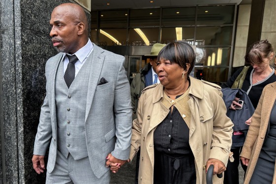 Kenneth Windley, left, leaves a courthouse with his mother, Francina Windley Patterson.