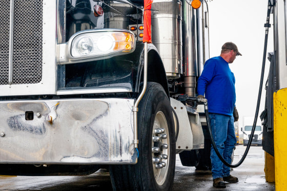 A man refills his diesel truck.