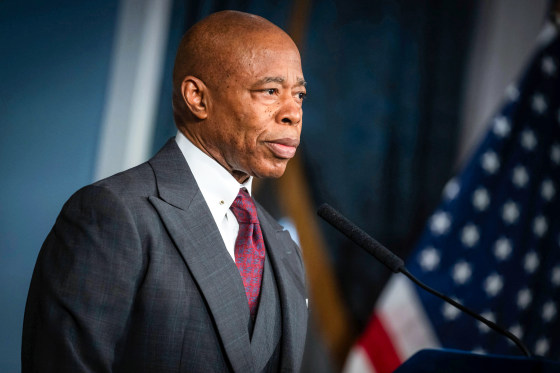 Eric Adams stands at a podium