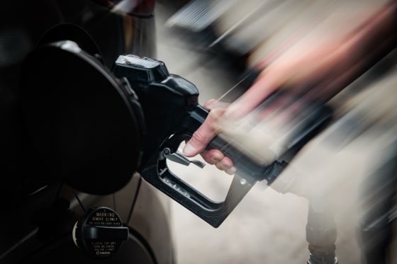 A person pumps gas at Penn Jersey Mart gas station, the image shows fast movement with a lens filter