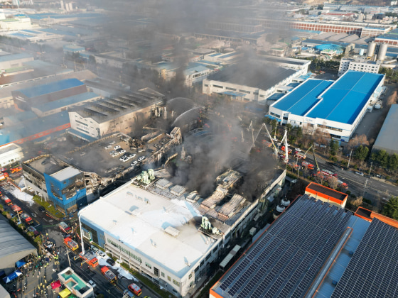 Firefighters spray water to extinguish a fire at a car parts plant in Daejeon on March 20.