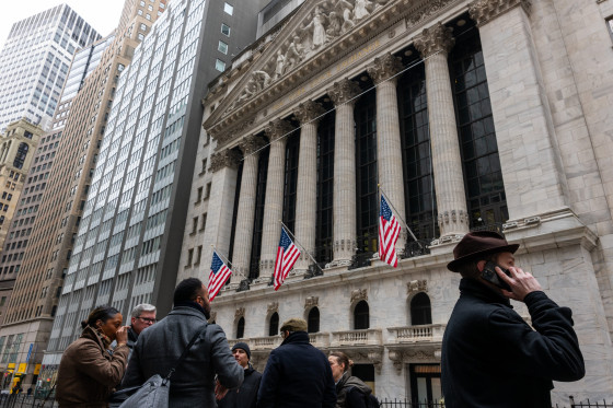 People walk outside of the New York Stock Exchange on March 19, 2026.