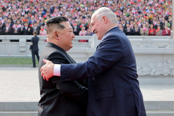 Image: Kim Jong Un greeting Belarus' President Alexander Lukashenko with a handshake and smile.