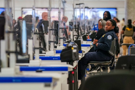 A TSA agent at a screening checkpoint.